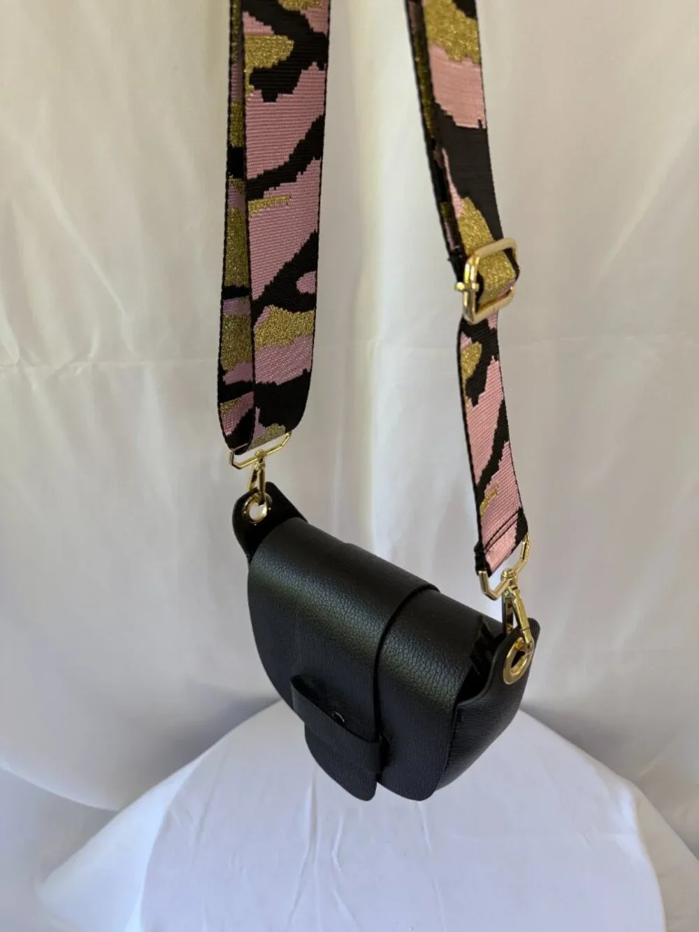 Black purse with pink and black camo strap